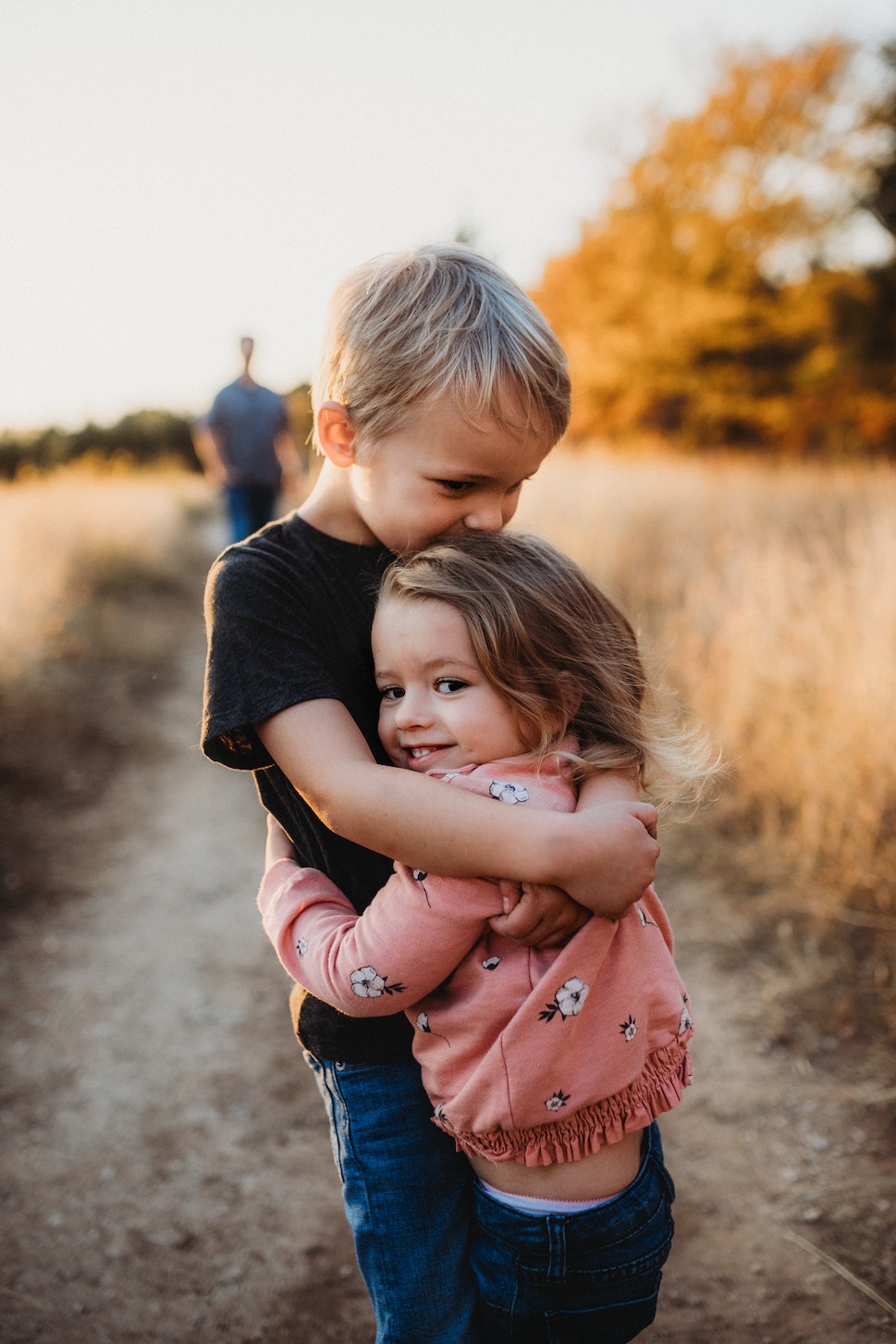 brother and sister hugging