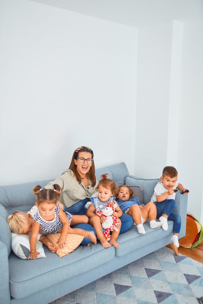 nanny with children on sofa